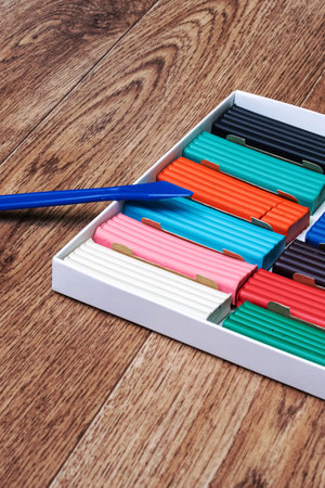 Multicolored plasticine in a box close up on a wooden backgroundの写真素材