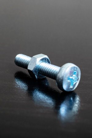 Bolt and nut on a wooden background