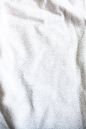 Folds on a white fabric close up