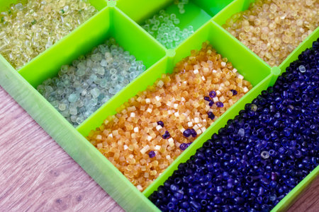 Colorful beads in containers close up, handicrafts, macrophoto