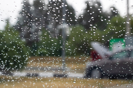 Raindrops on glass against the background of the cityの写真素材