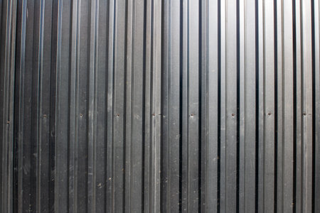 Black fence made of corrugated board, background or textureの写真素材