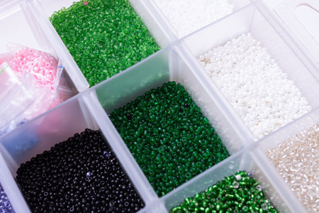 Colorful beads in containers close up, handicrafts, macrophoto