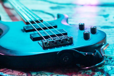 Electric guitar on the floor in blue lighting close up