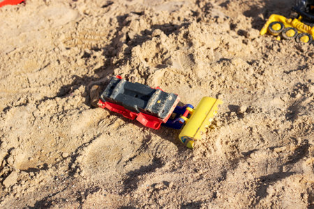 Children's toy car in the sand close upの写真素材