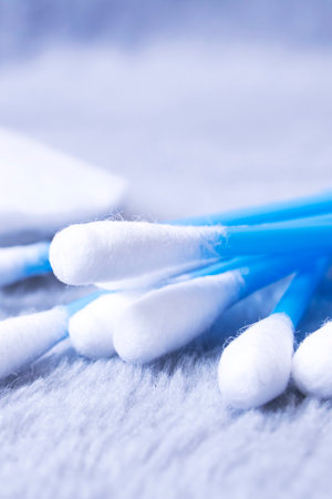 Cotton swabs and cotton pads on a gray backgroundの写真素材