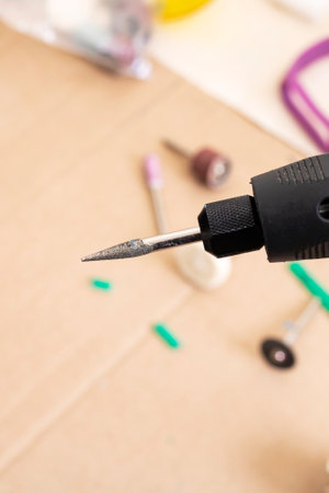 Engraver in hand on the desktop background close upの写真素材