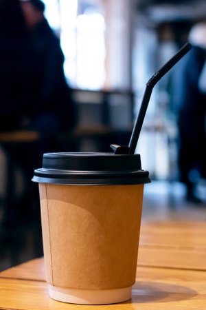 Paper coffee cup on table in cafe close upの写真素材