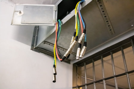 Colored wires hanging from the ceiling closeup