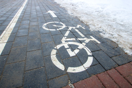 Bicycle path sign on the snow closeupの写真素材