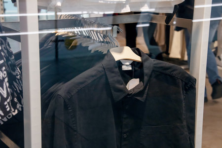 Black shirts on hangers in store close upの写真素材