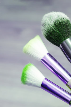 Three makeup brushes on gray background close upの写真素材