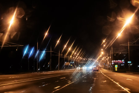 Night road in fog with yellow lanterns, darkの写真素材