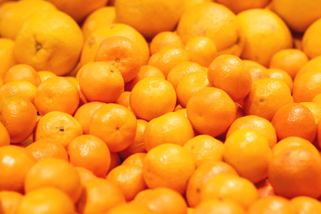 Heap of orange tangerines close up background or textureの写真素材