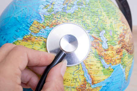 Stethoscope on a globe background close up