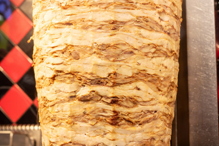 Meat for shawarma is fried on a spit close upの写真素材