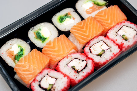 Bright beautiful rolls with fish close up on gray backgroundの写真素材