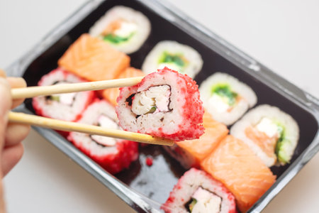 Bright beautiful rolls with fish close up on gray backgroundの写真素材