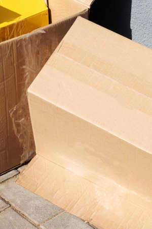 Empty cardboard boxes after moving close up in sunlight