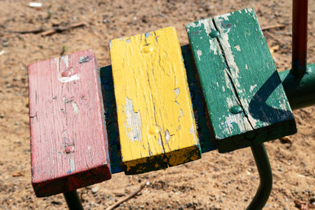 Old wooden swing in the yard of the houseの写真素材