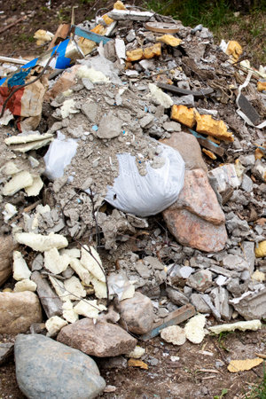 Pile of construction waste on the green grassの写真素材