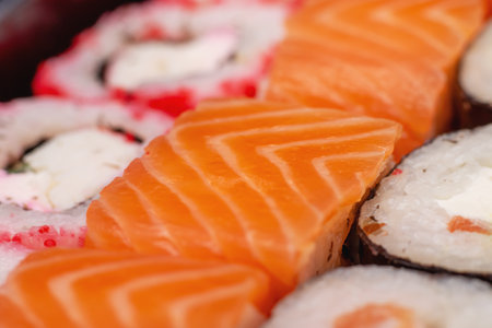 Bright beautiful rolls with fish close up on gray backgroundの写真素材