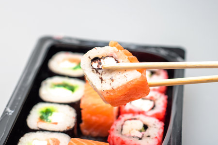 Bright beautiful rolls with fish close up on gray backgroundの写真素材