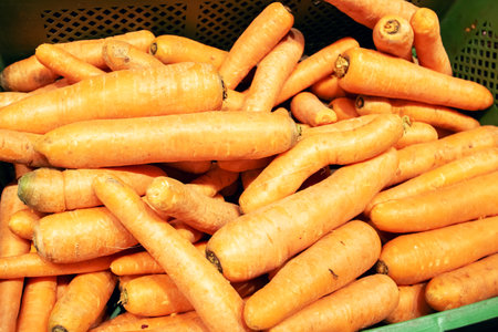 A pile of bright yellow carrots close upの写真素材