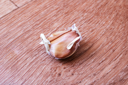One garlic clove on wooden table close upの写真素材
