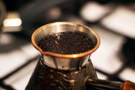 Coffee is brewed in a retro cezve on the stoveの写真素材