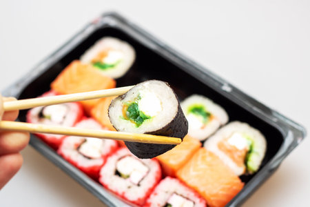 Bright beautiful rolls with fish close up on gray backgroundの写真素材