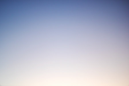 Blurred blue sky at sunset close up, graphient backgroundの写真素材