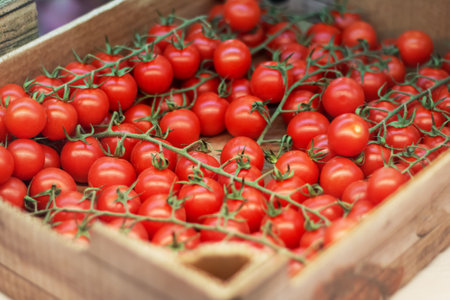 Cherry tomatoes in a wooden container close upの写真素材