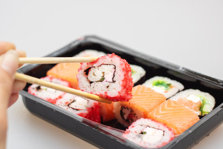 Bright beautiful rolls with fish close up on gray backgroundの写真素材
