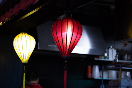 The restaurant is adorned with a row of colorful lanterns hanging from the ceiling, creating a...