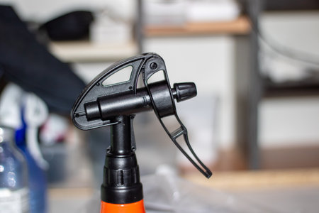 In the closeup image, a spray bottle is clearly displayed on a table, showing its design and function effectivelyの写真素材