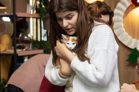 Belarus, Minsk - December 17, 2023: Woman holding a kittenのeditorial素材