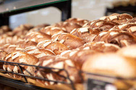 A large assortment of freshly baked bread is sitting on a shelfの写真素材