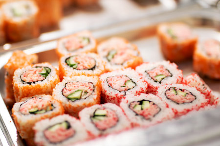 A tray filled with delicious sushi featuring crab and cucumberの写真素材