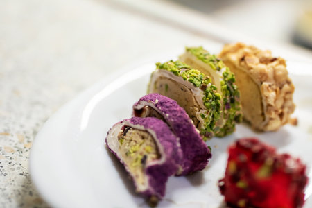 There are three distinct types of delicious desserts artistically arranged on a pristine white plate, enhancing their appeal and presentationの写真素材