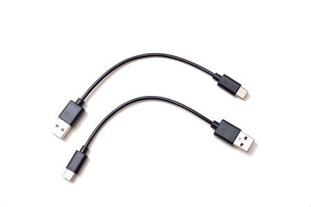 On a clean white background, two USB cables are connected to each other, creating a visual...