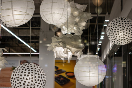 A beautiful arrangement of white polka dot lanterns gracefully hanging down from the ceiling, creating an enchanting atmosphere for allの写真素材