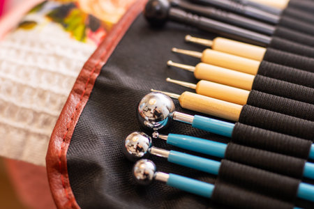 There is a collection of various brushes neatly arranged in a case resting on a table surface, ready...