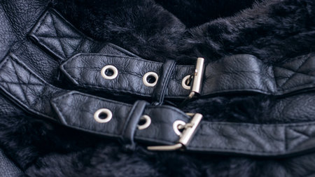 This trendy black leather jacket features luxurious fur lining and stylish buckle accents for a chic...