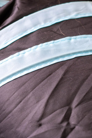 This image depicts a closeup view of a brown cloth that features white trimの写真素材