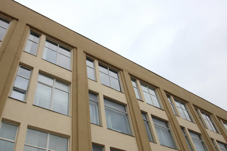 A wonderful balcony positioned on the side of a beautiful building featuring charming arched windows...