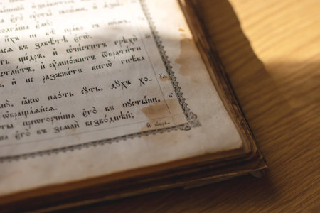 A book lies open to a specific page featuring intricate Russian writing printed or handwritten on it, showing a beautiful languageの写真素材