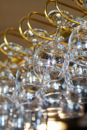 A collection of wine glasses elegantly hanging from a stylish rackの写真素材