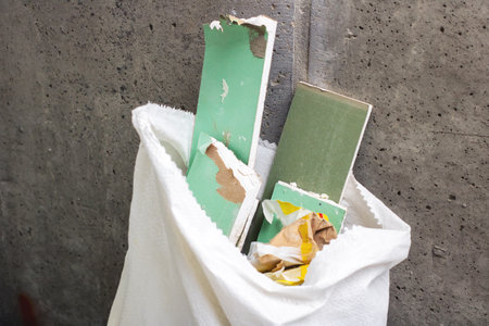 A white bag that is filled with various green and white pieces of paper, creating a colorful...