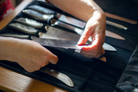 A person expertly and skillfully handles a sharp kitchen knife, showcasing both culinary expertise and necessary safetyの写真素材